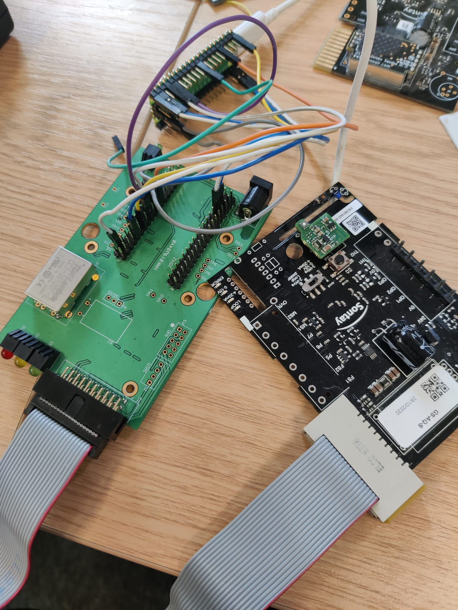 Connected controller boards and a Raspberry Pi Pico in a platform migration and verification setup